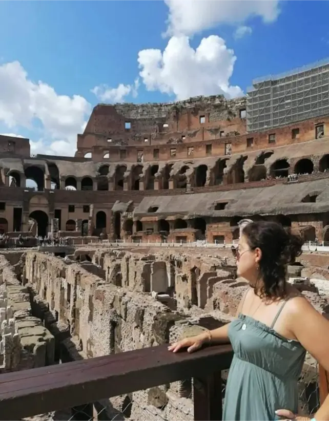 Maria admiring a historic monument in Greece, blending travel with artistic inspiration.