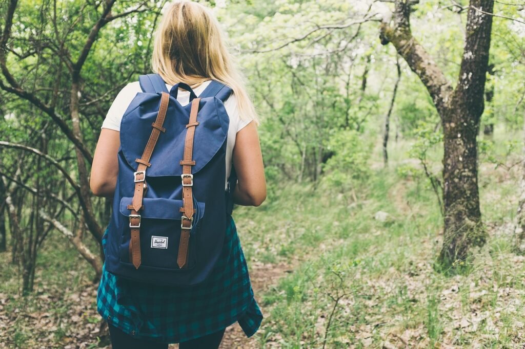 A confident English learner on an adventure with books and headphones, symbolizing growth and independence