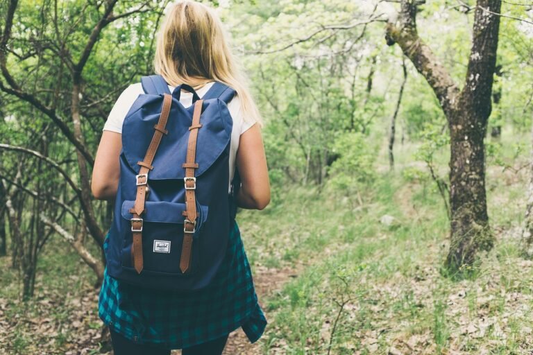 A confident English learner on an adventure with books and headphones, symbolizing growth and independence